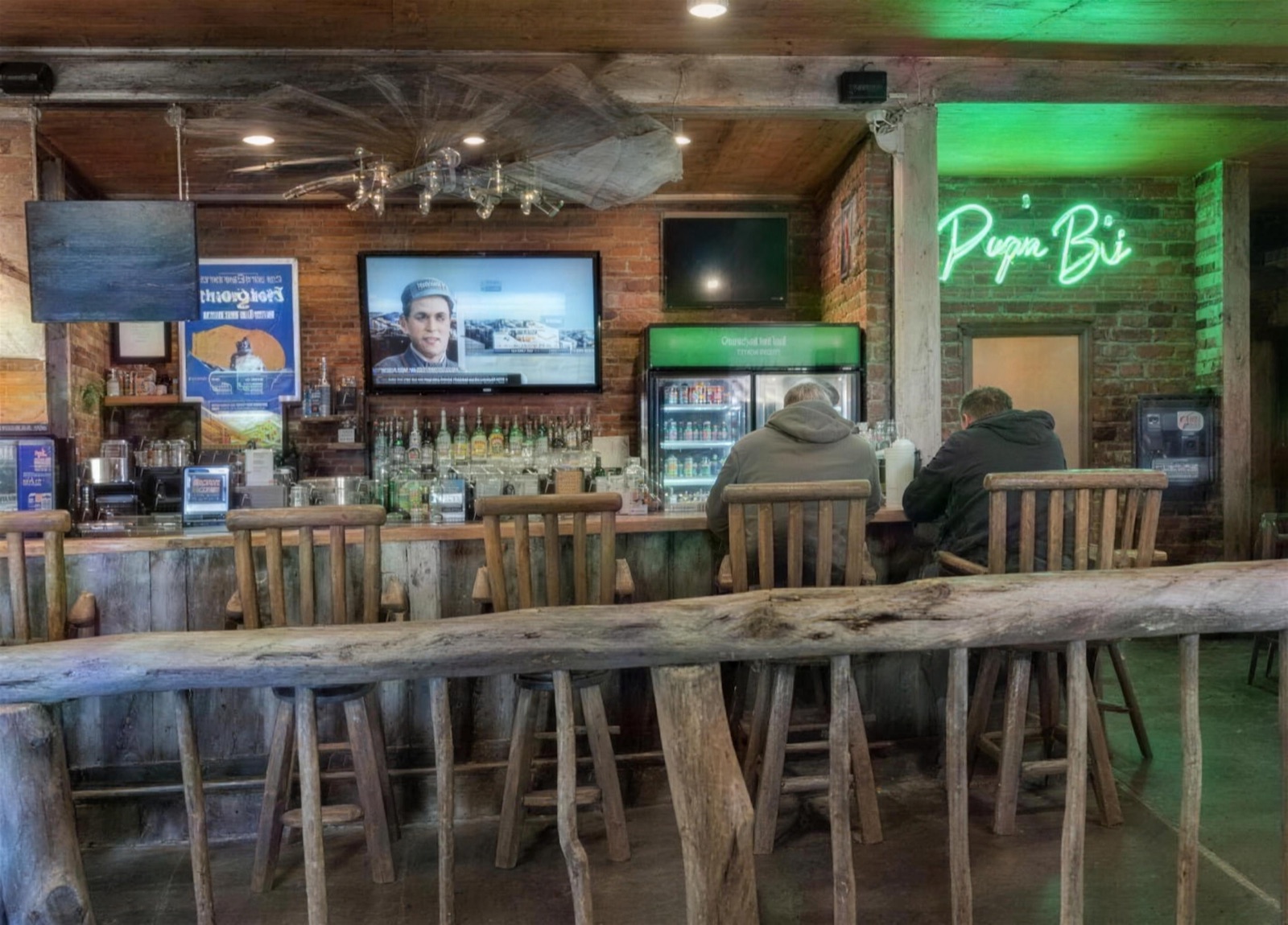 The log-stool bar at Papa B's with the neon sign glowing
