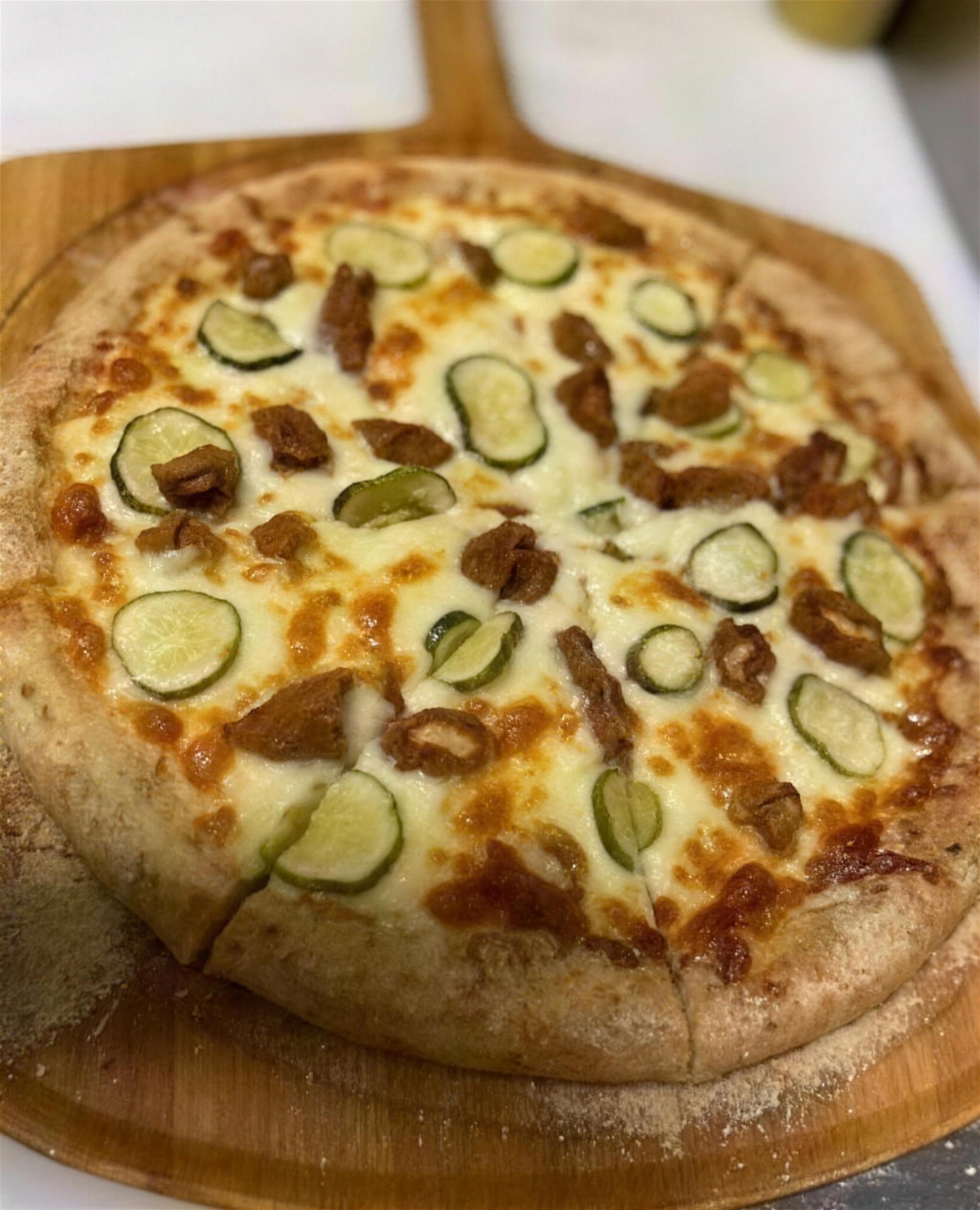 Hand-crafted pizza on a wooden board at Papa B's